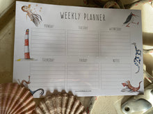 Load image into Gallery viewer, Weekly planner. 50 pages of high quality paper with Britt&#39;s artwork featuring. Light gift to post. Suitable for all ages. Useful for work, rest or play.

